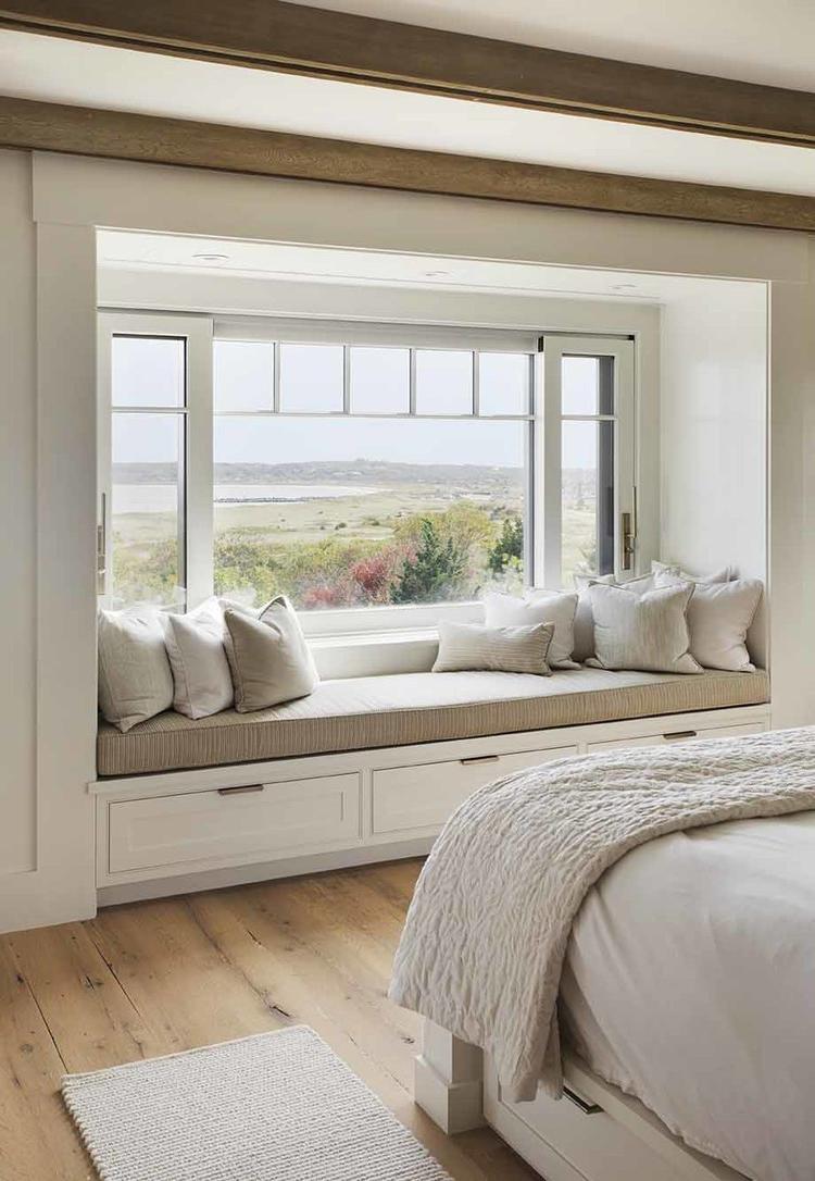Window seat in bedroom with a view of the water